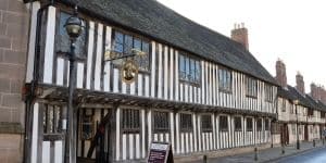 Shakespeare's schoolhouse and Guildhall building exterior shot - long tudor building in black and white